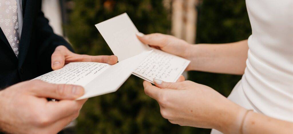 Couple reading privates notes to each other on their wedding day.