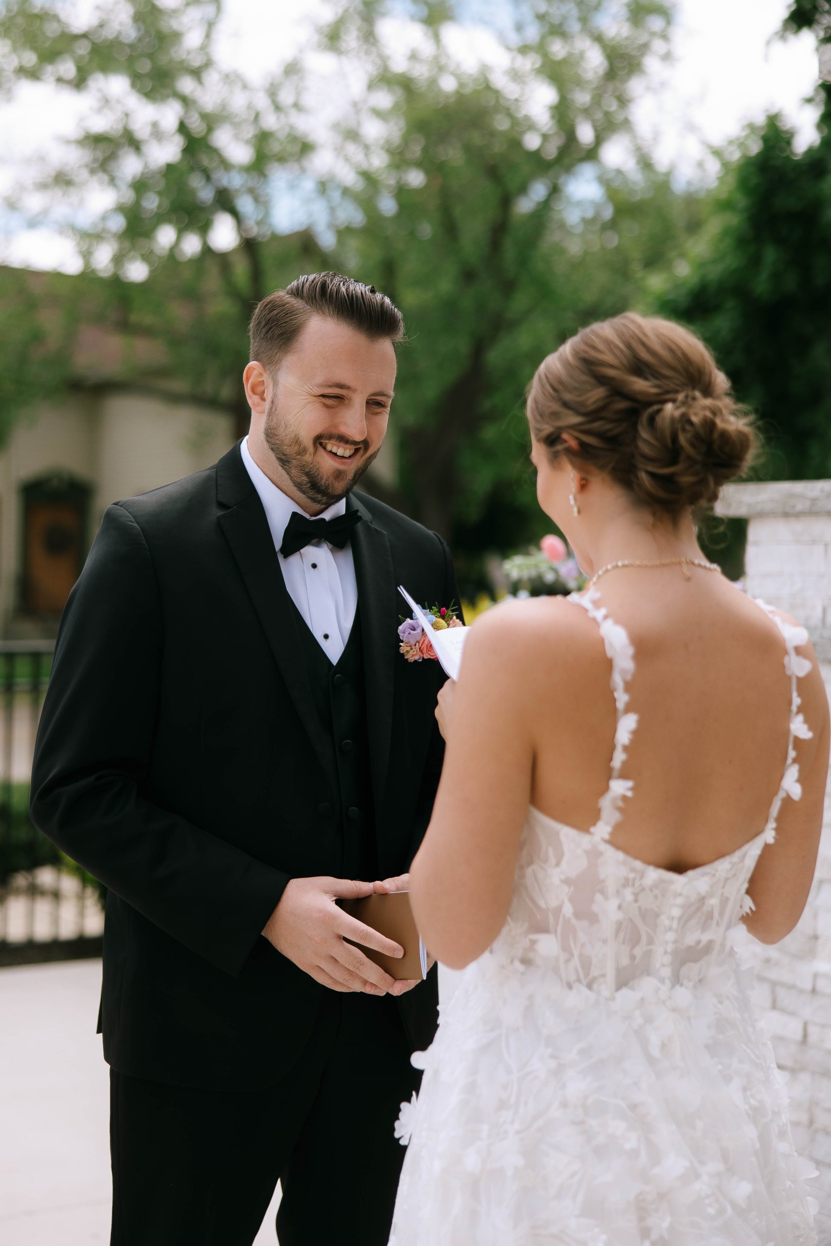 Groom smiles as the bride reads her vows during a private first look at 10 South.