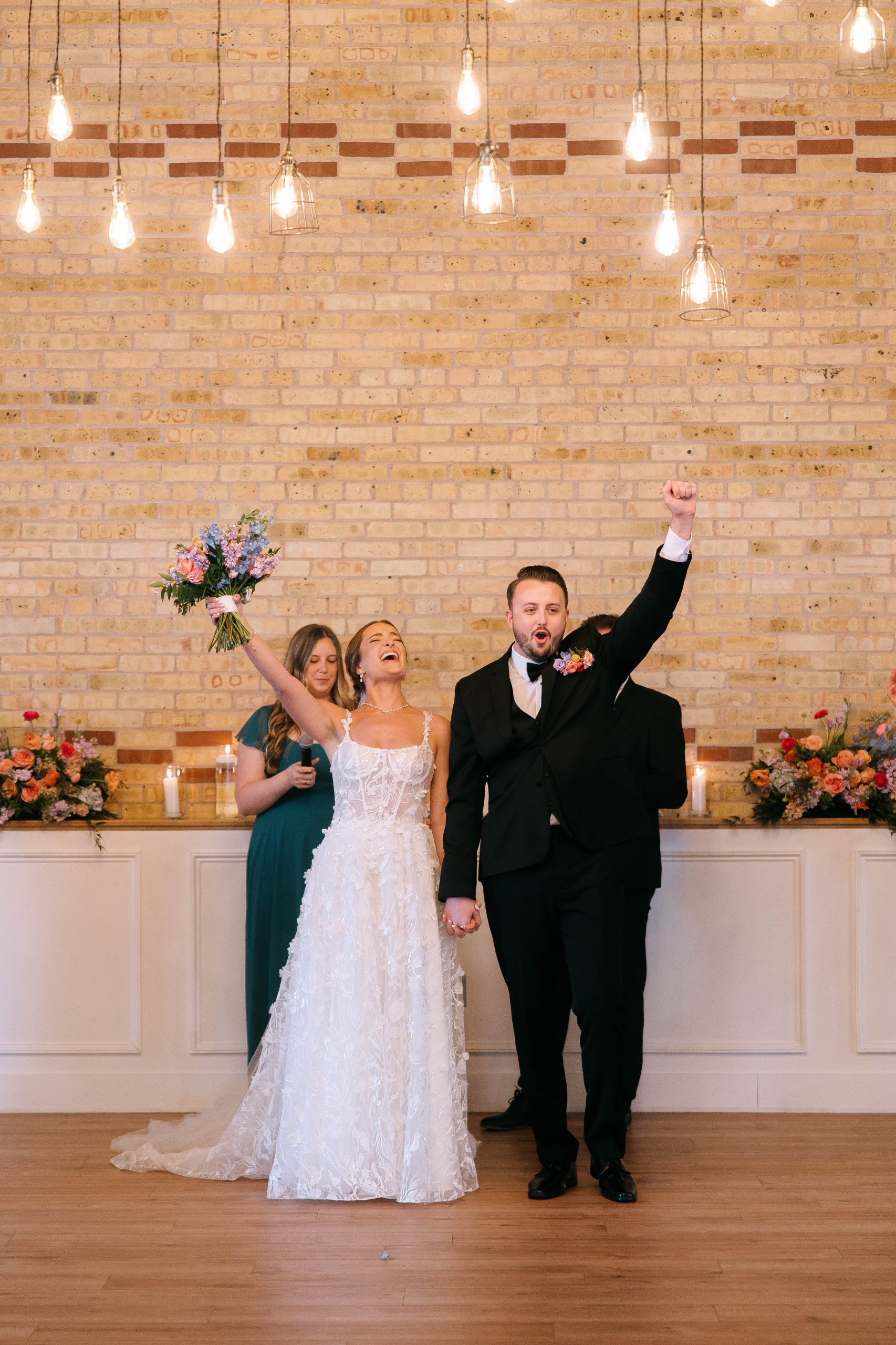 Bride and groom celebrating during indoor wedding ceremony at 10 South in Janesville, Wisconsin