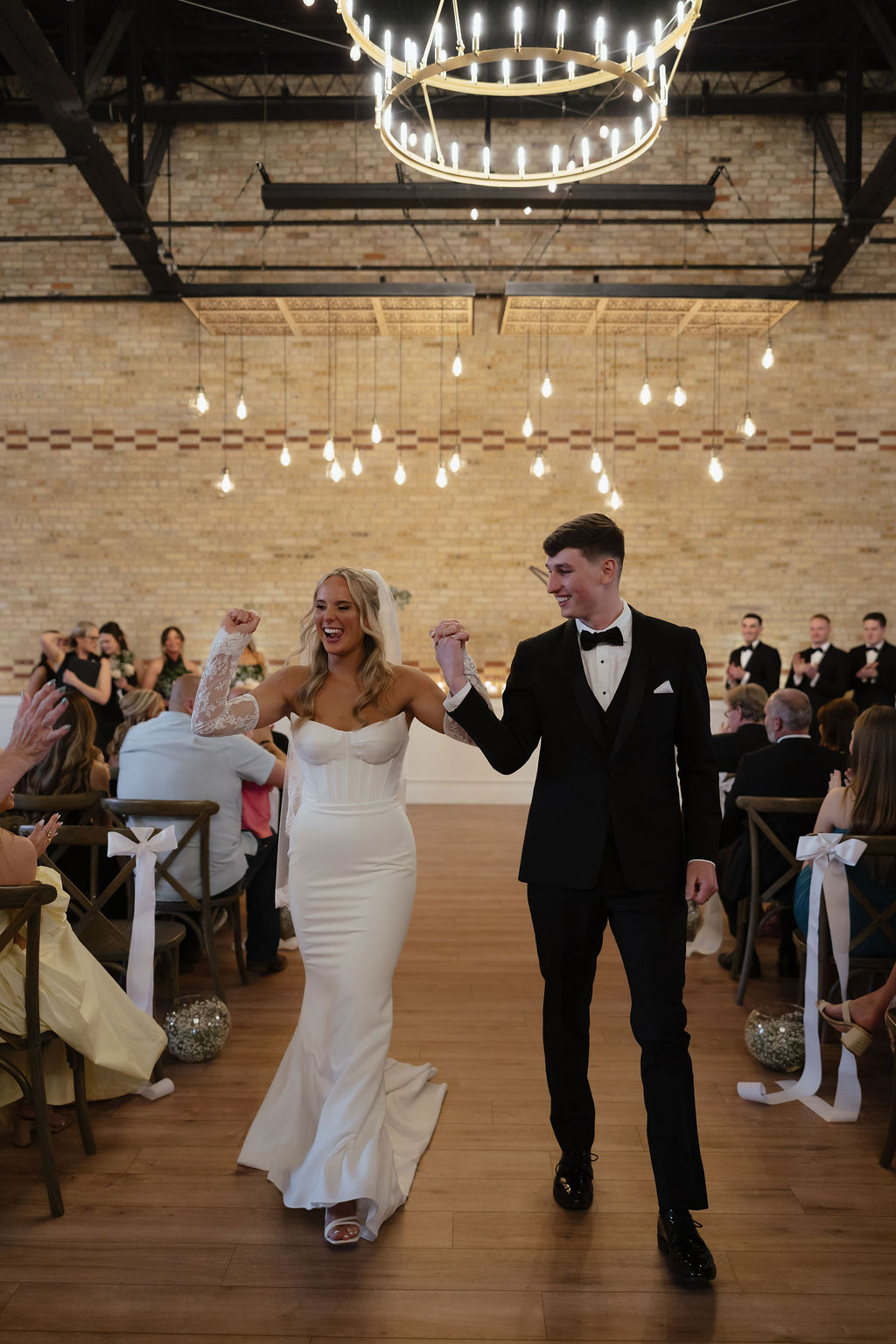 Bride and groom celebrating down the aisle at 10 South wedding ceremony