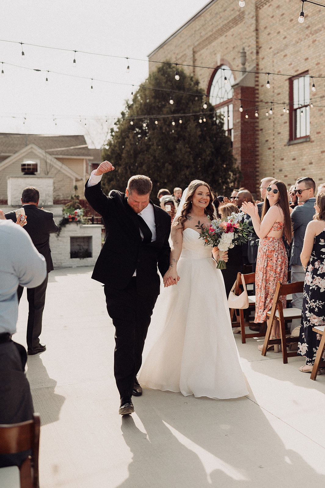 Bride and groom celebrating their wedding ceremony exit at 10 South in Janesville, Wisconsin