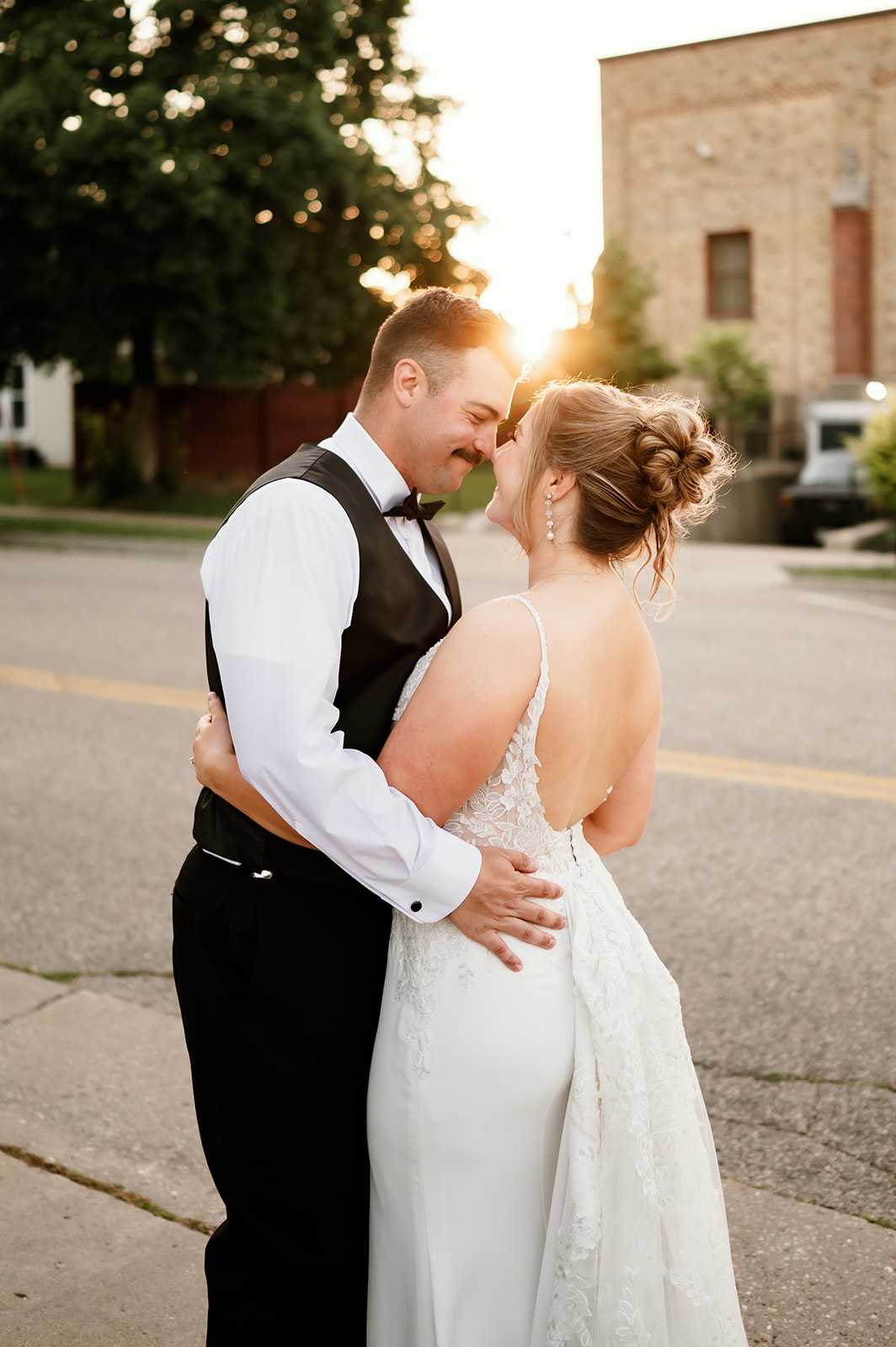 Bride and groom embrace at sunset outside 10 South wedding venue in Janesville, Wisconsin.