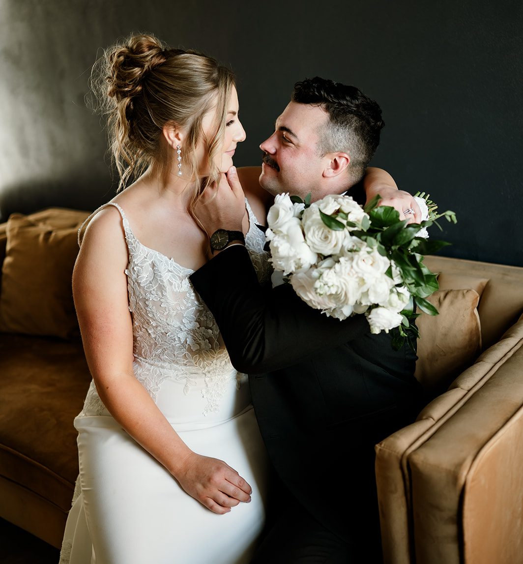 Bride and groom share a joyful moment indoors at 10 South wedding venue in Janesville, WI.